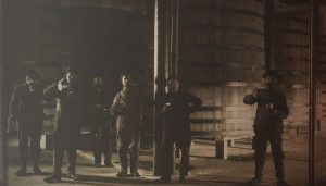 employees in front of beer brewing barrels in 1864