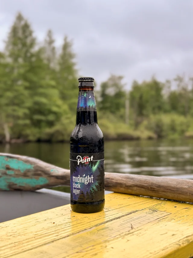 Sippin' a cold dark beer where the tree line meets a still lake - nature's version of happy hour.